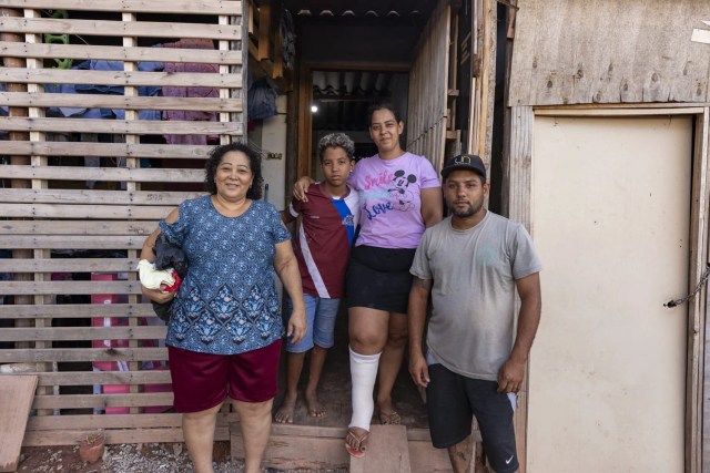 Jean Batista em frente à casa que construiu com a esposa, Milena Peixoto, o filho e a sogra, Givaneide Mariano